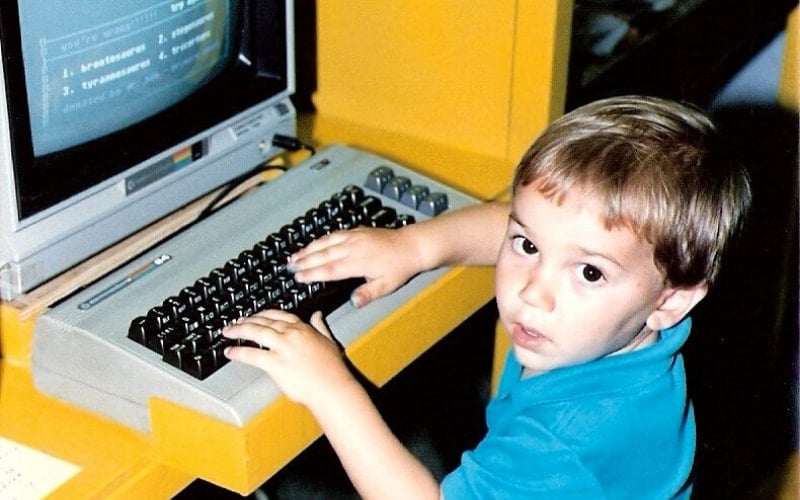 Small Michael 1980s photo of a toddler typing at the computer.